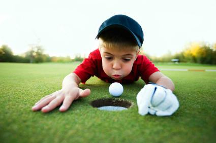 Junior playing golf